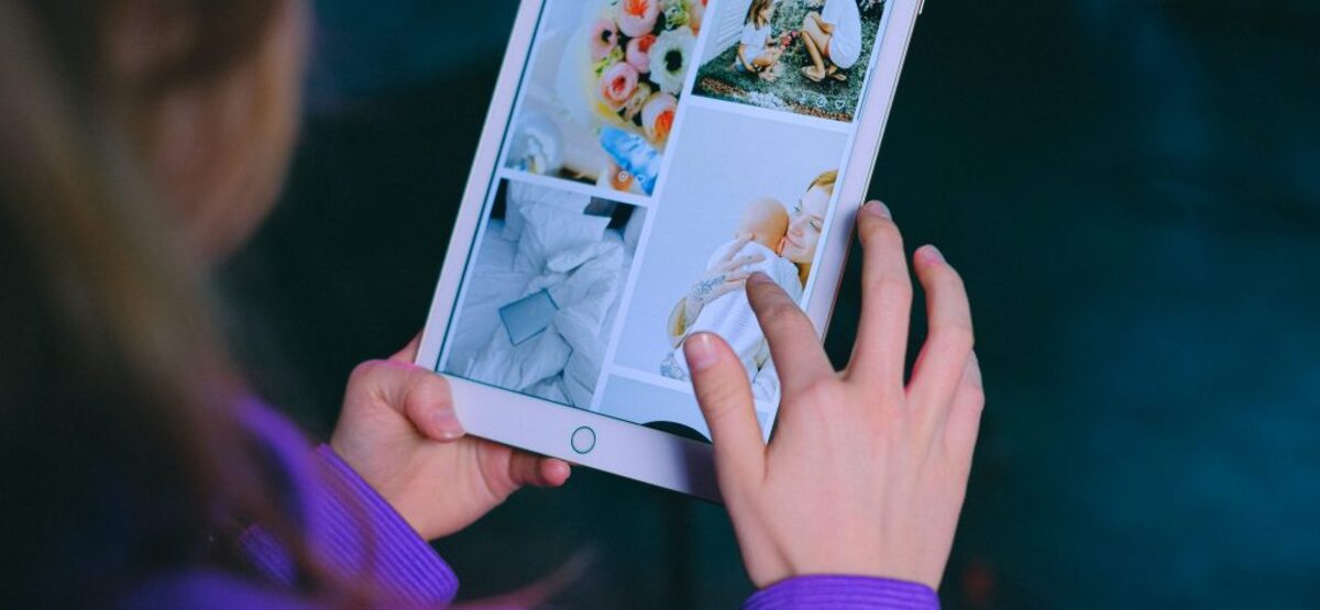 Unrecognizable woman browsing modern tablet