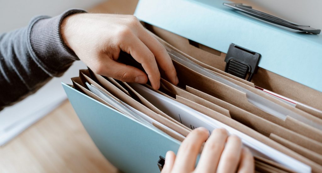 Person choosing document in folder