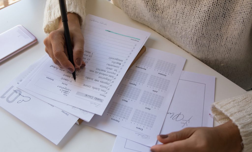 person writing on white paper