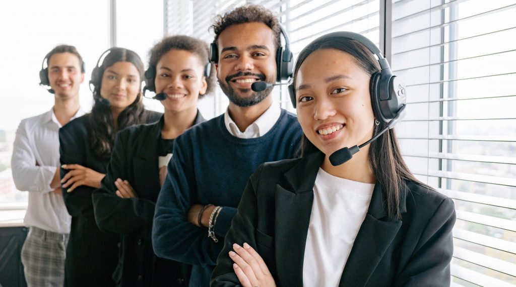 Happy call center agents looking at camera