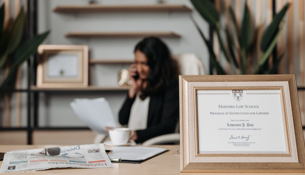 Selective focus photo of a diploma on a frame