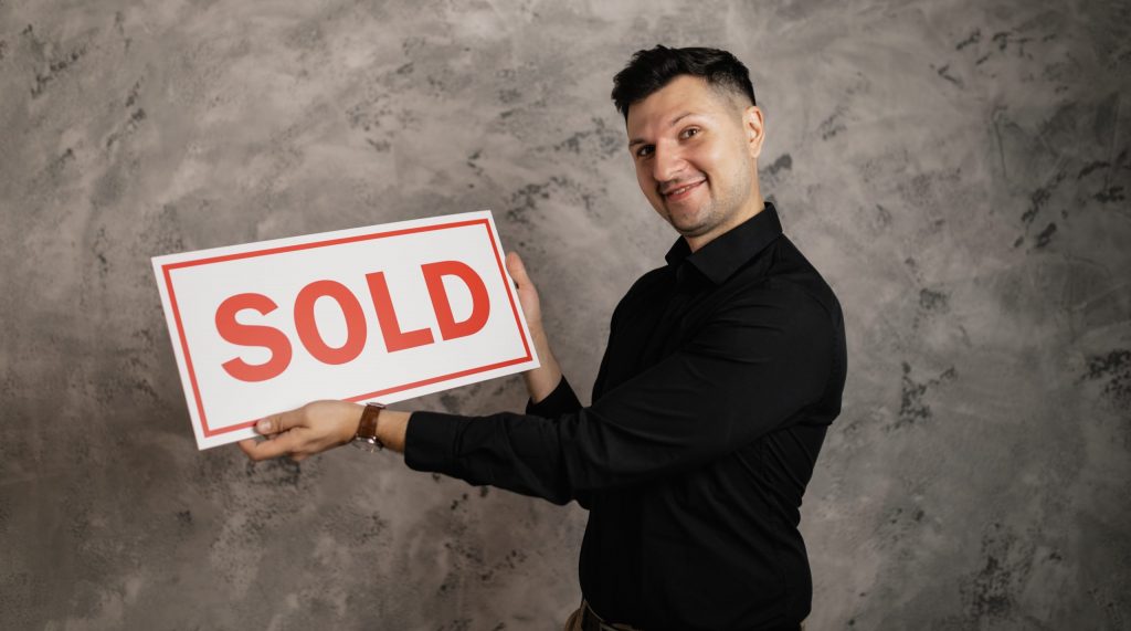 Man holding a signboard smiling