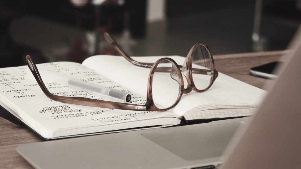 Glasses notebook and laptop