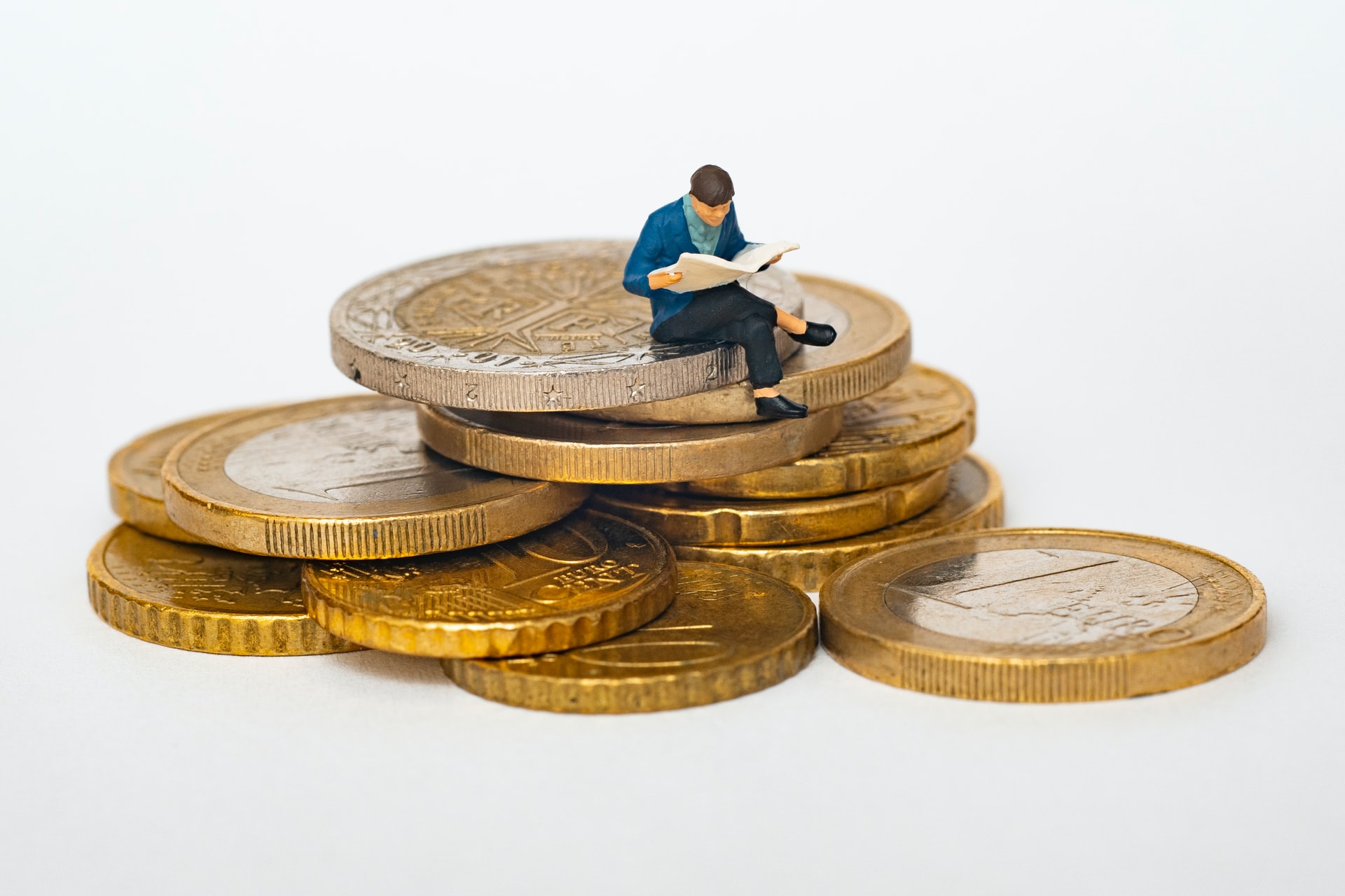 figurine sitting on coins