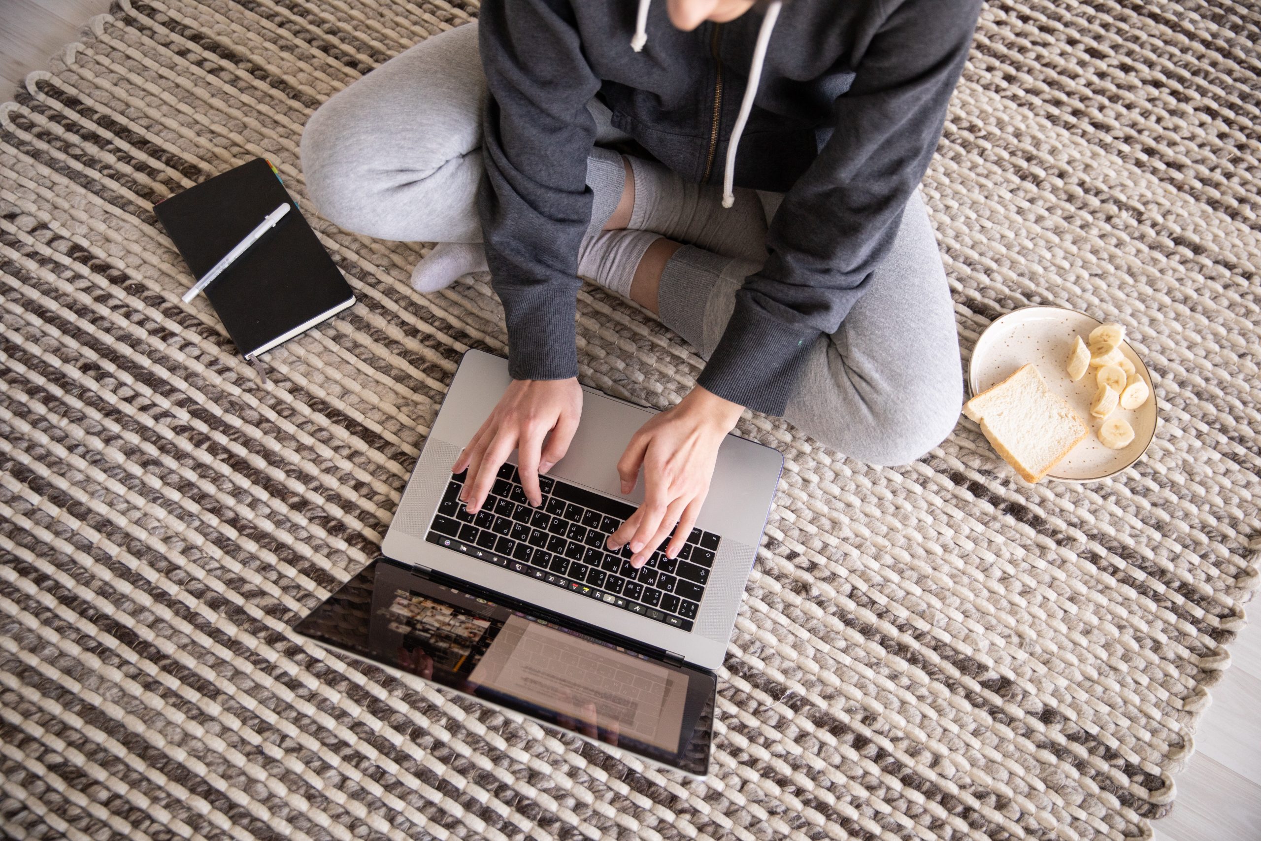 person working on laptop at floor